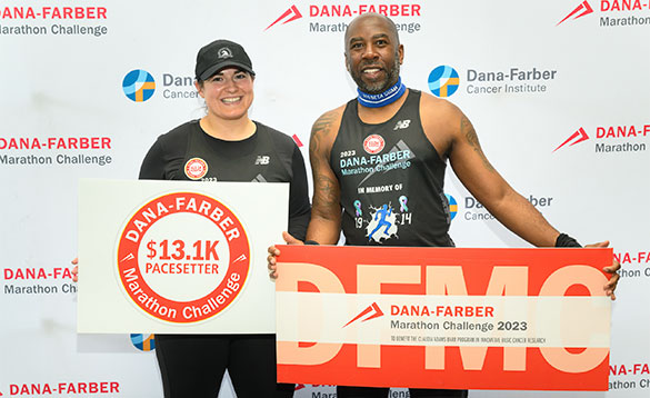 Dana-Farber Marathon Challenge runners holding DFMC signs