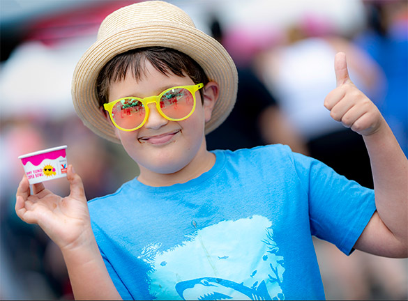 A kid poses for a photo with some ice cream at the Jimmy Fund Scooper Bowl