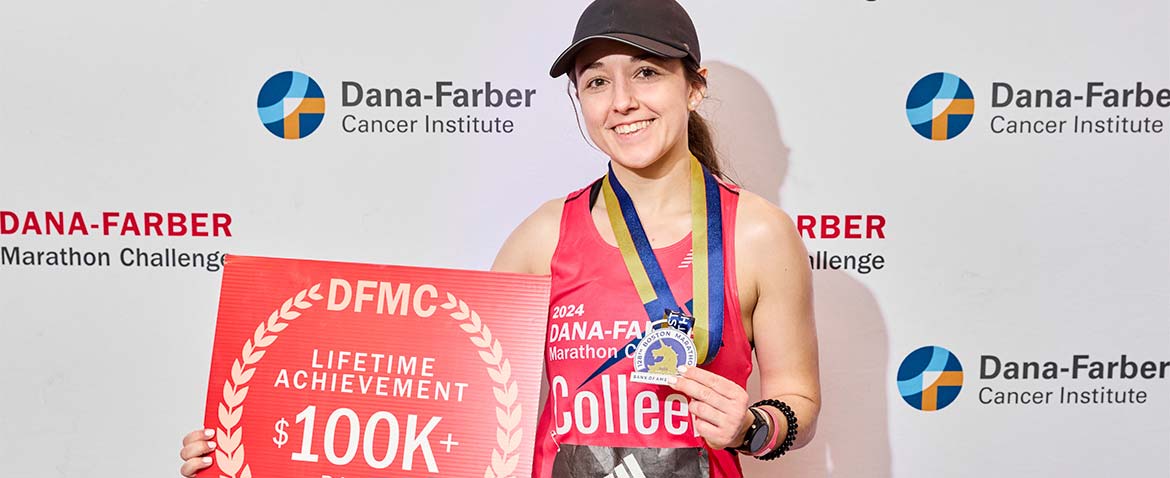 Dana-Farber Marathon Challenge runner with a medal and a $100,000 lifetime achievement sign