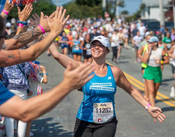 A Run for Dana-Farber runner high-fives supporters