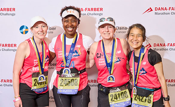 Four Dana-Farber Marathon Challenge runners with their medals after the race