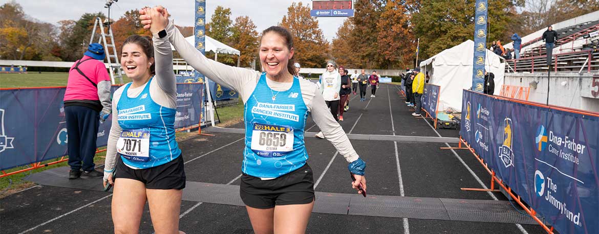 Two Run for Dana-Farber runners celebrate after finishing a race