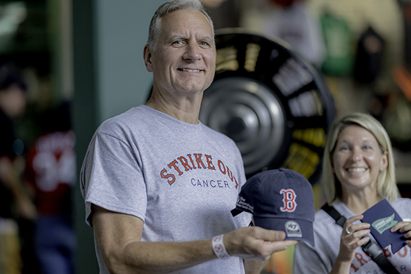A Radio-Telethon volunteer poses with event merchandise at Fenway Park