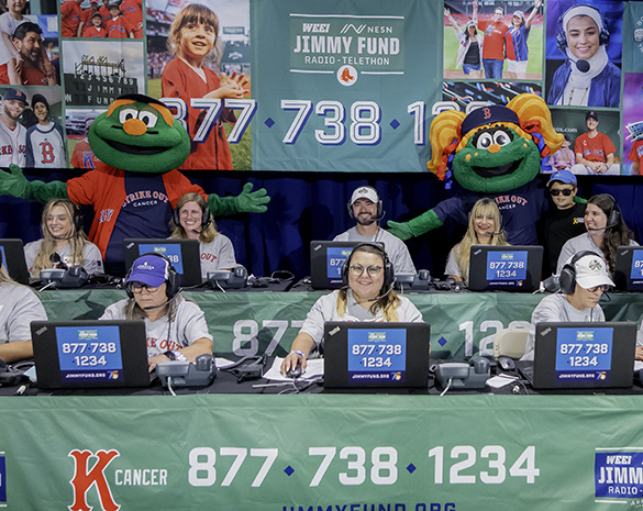 Volunteers answer phones at Radio-Telethon with Red Sox mascots Wally and Tessie providing support