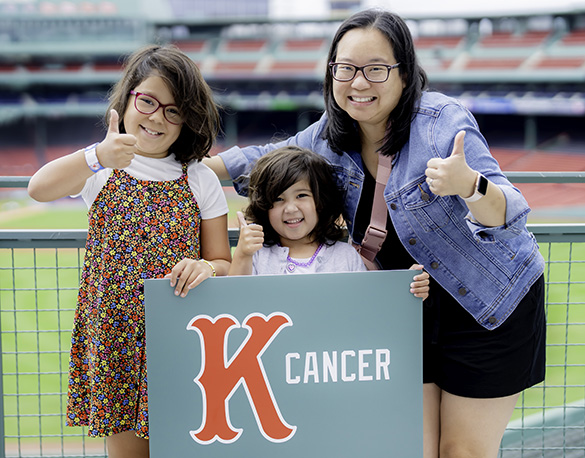 A family holds up a K-Cancer sign in Fenway Park