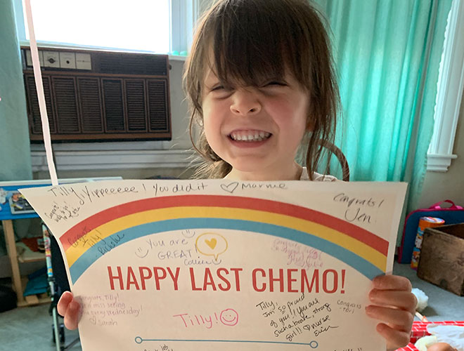 Dana-Farber's Jimmy Fund Clinic patient, Tilly, holding a Happy Last Chemo sign