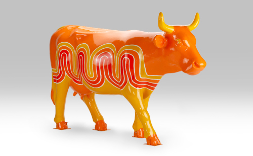 Orange and red cow facing right