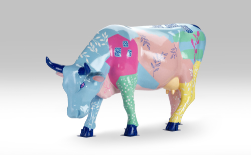 Pink cow with flower design facing left