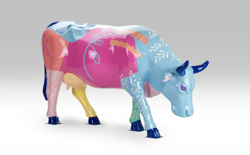 Pink cow with flower design facing right