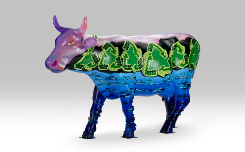 Colorful cow with recycle symbols facing left