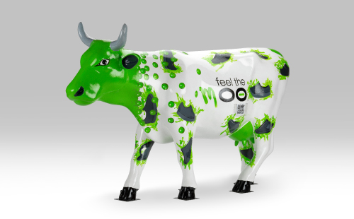 Green and white cow with shoes facing left