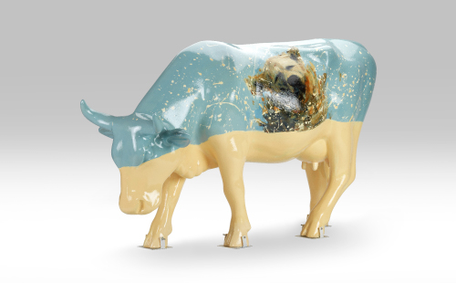 Cow with a dog painted on it facing left