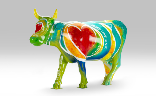 Green cow with heart design facing left