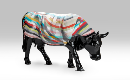 Cow covered by a blanket facing right