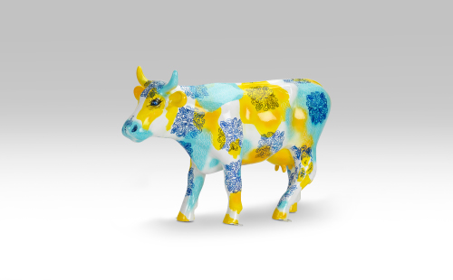 Blue and yellow mini cow facing left