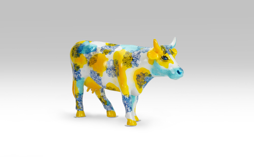 Blue and yellow mini cow facing right