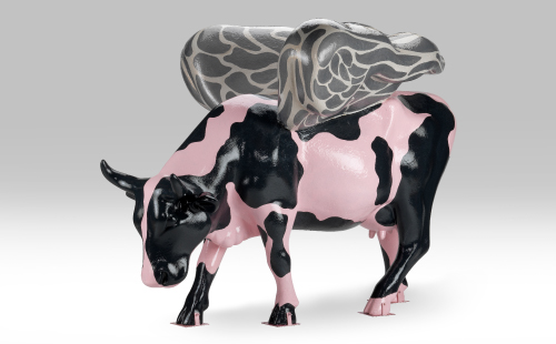Cow painted like a pig with wings facing left