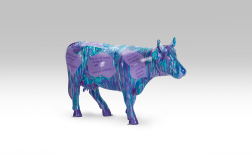 Blue and purple mini cow covered in jokes facing right