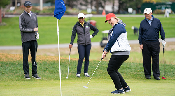 Jimmy Fund golfers trying to sink a putt during the 2022 Jimmy Fund Golf season