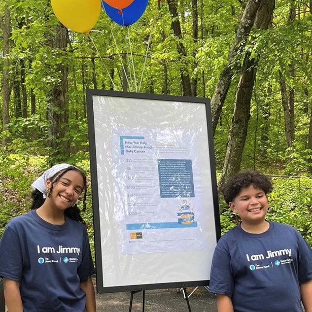 Two young JimmyFundRaisers standing with a Jimmy Fund sign