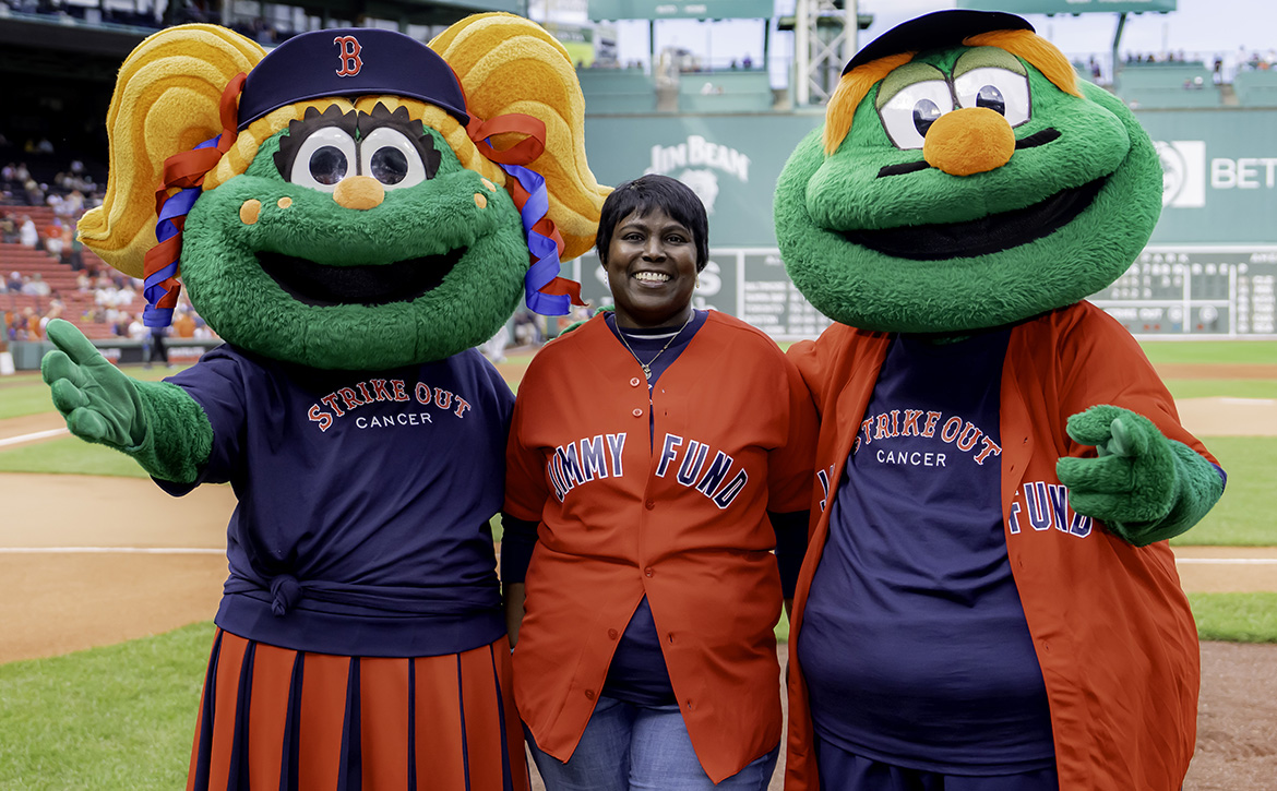 A Dana-Farber patient poses with Red Sox mascots Tessie and Wally